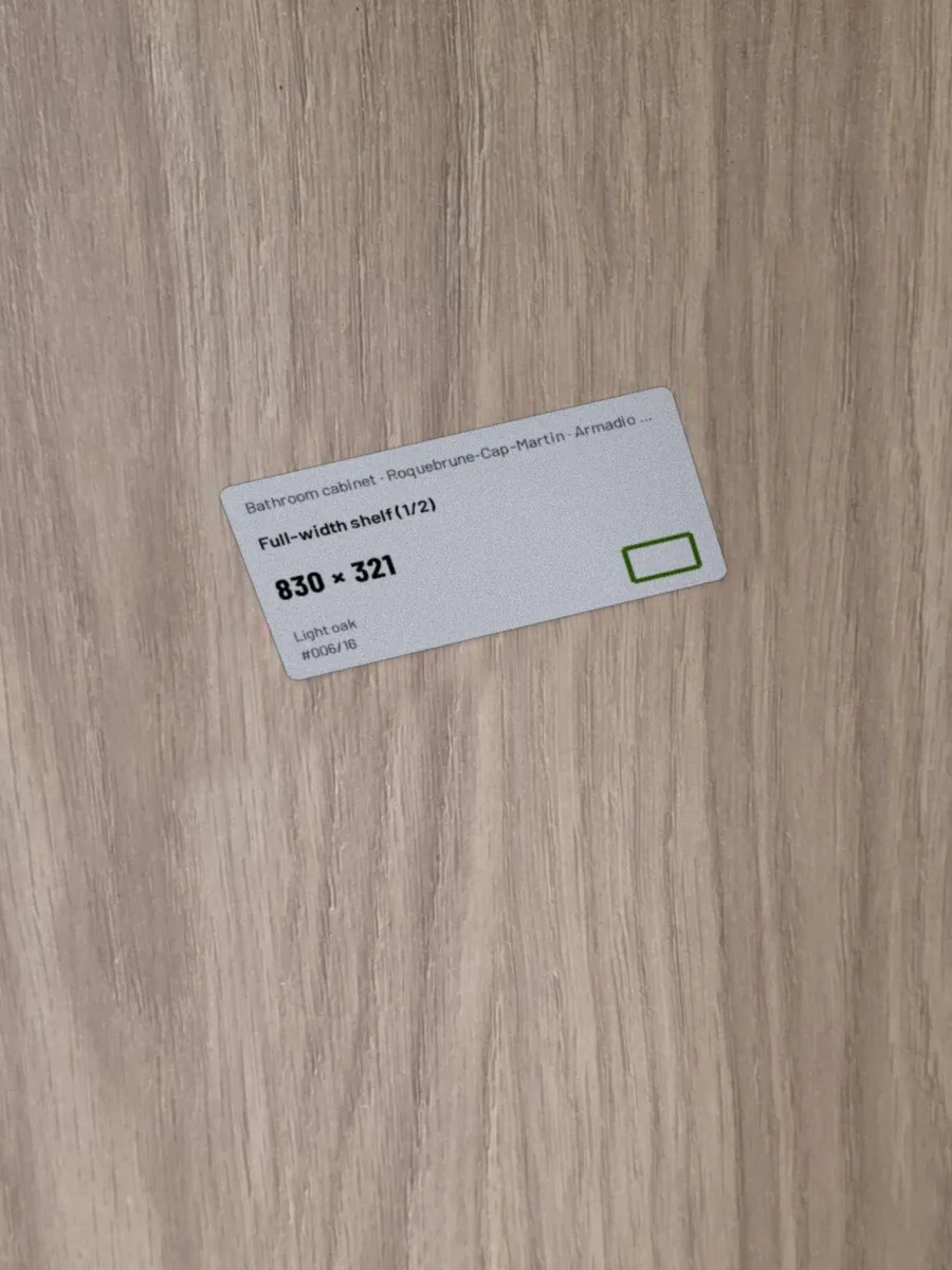 Full-width shelf · illustration: the part's real label, placed digitally on the photo of the panel