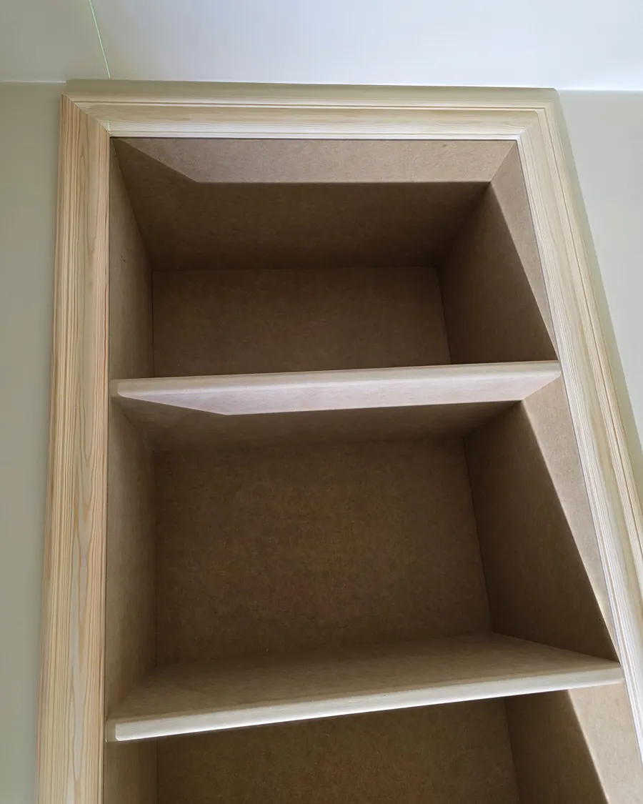 Built-in niche in raw MDF with a pine frame, before painting